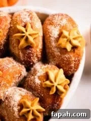 pumpkin donuts with piped filling peaking out in casserole dish