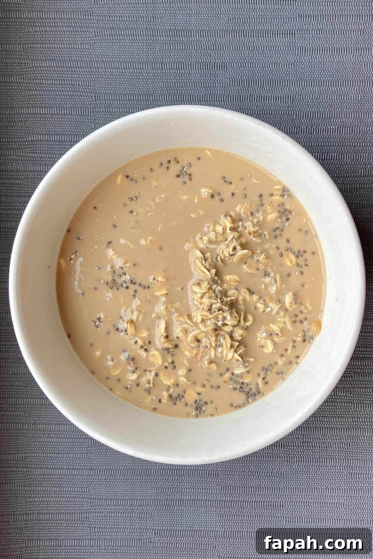 Mixing oats and milk in a bowl.