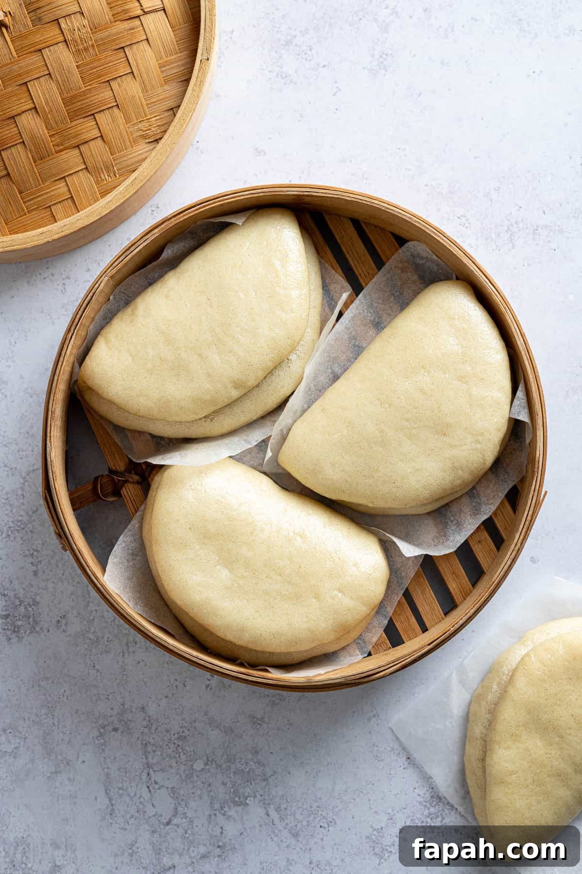 The cooked buns in the bamboo steamer.