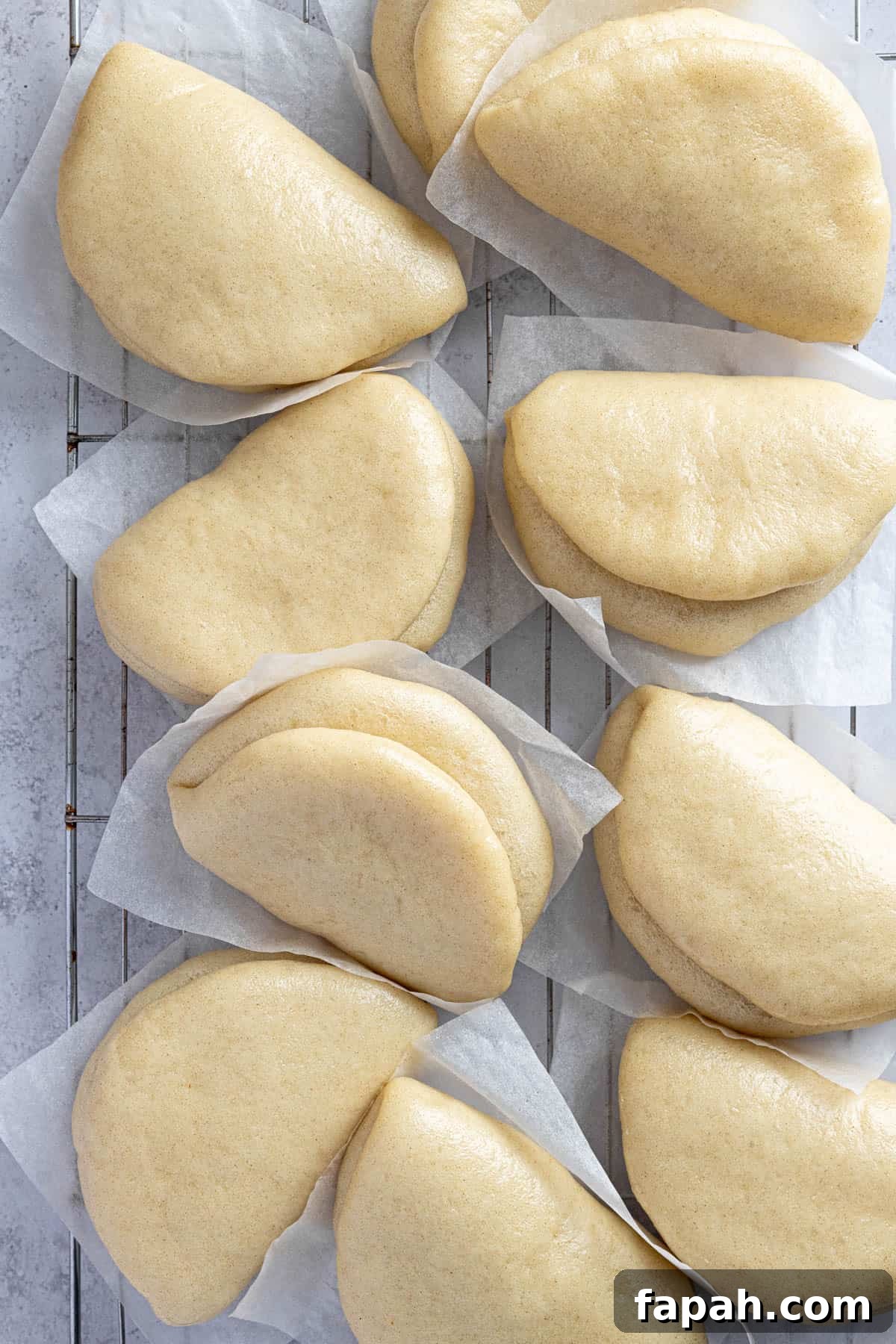The bao buns on a wire cooling rack.
