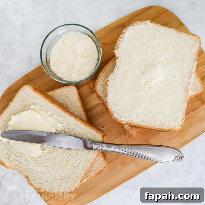 15 Creative Recipes for Using Leftover Bread 5 Overhead view of slices of bread with butter and one with the Parmesan cheese coating the butter.