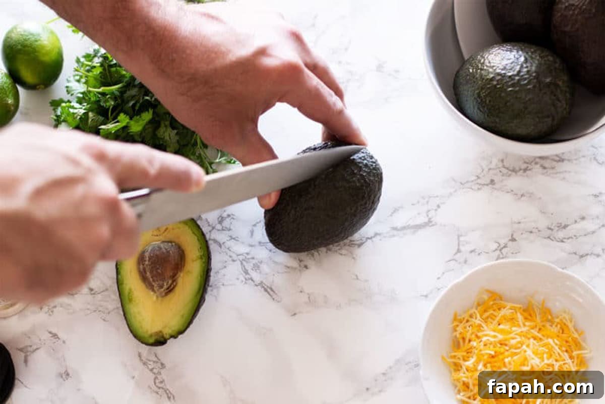 Creamy Homemade Guacamole Recipe for Parties and Everyday Meals 4 Slicing an avocado for this simple guacamole recipe