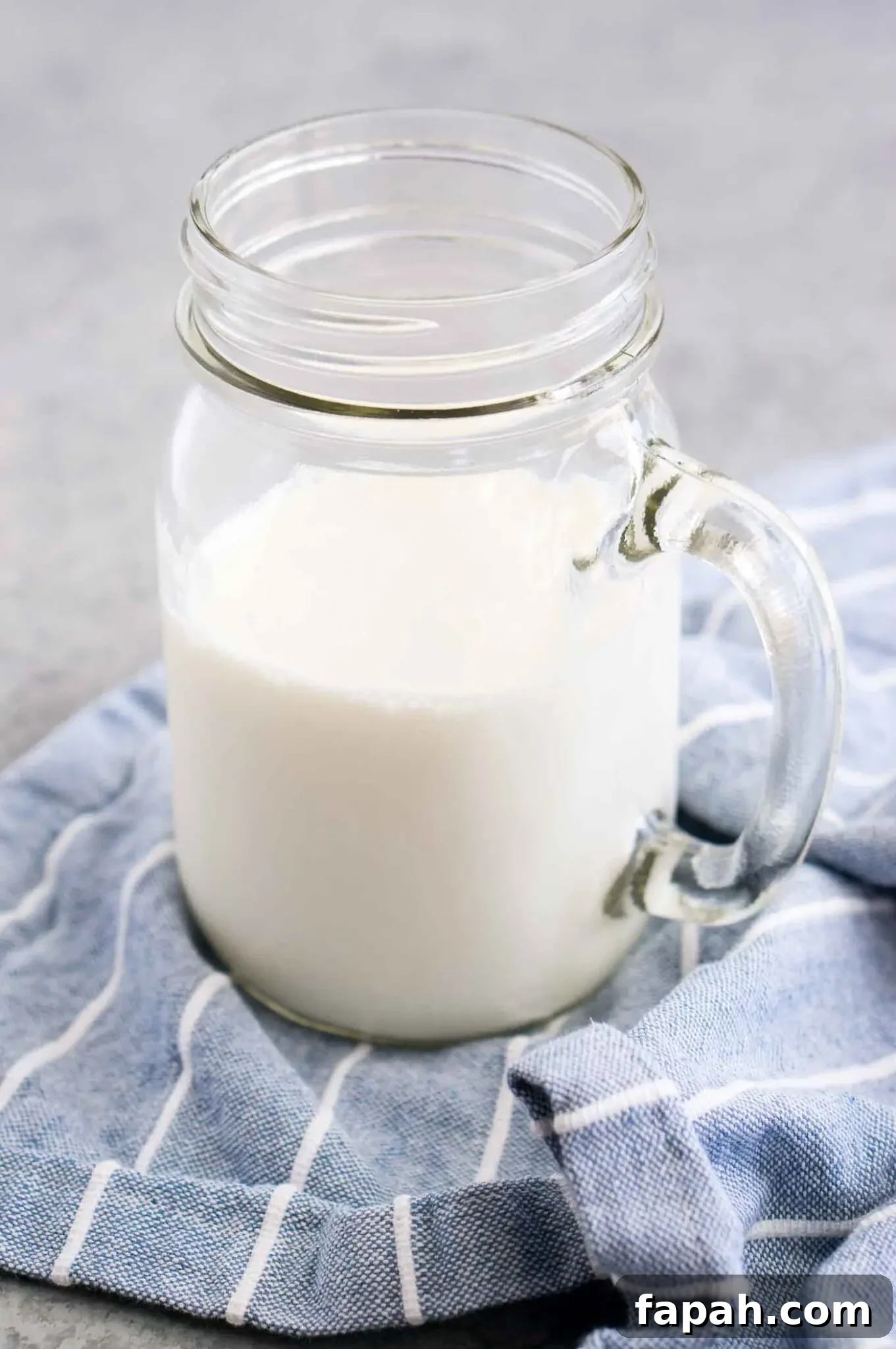 close up image of buttermilk in a glass jar
