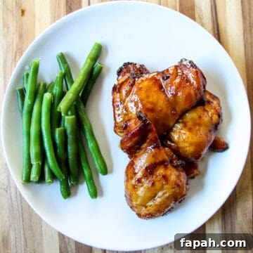 Air Fried Teriyaki Chicken on a white plate with green beans.