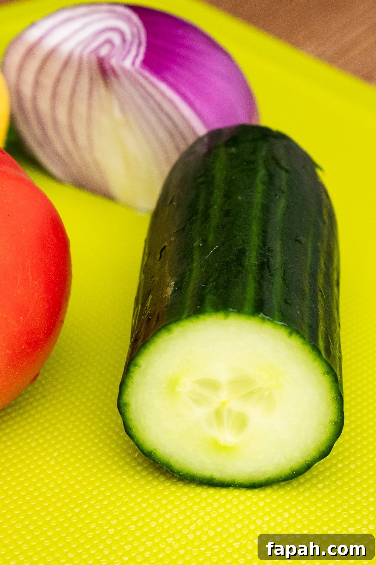 Quarter of cucumber on a chopping board