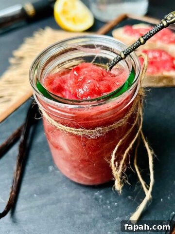 Rhubarb and gin jam in a glass jar.