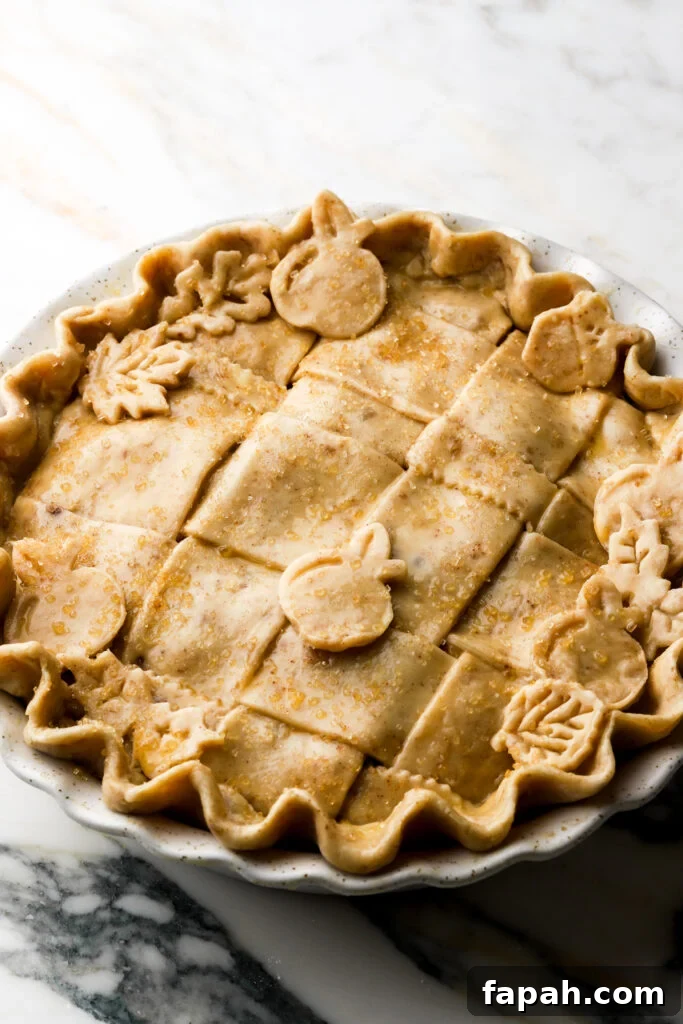 apple shapes on top of lattice pie crust with egg wash and sugar