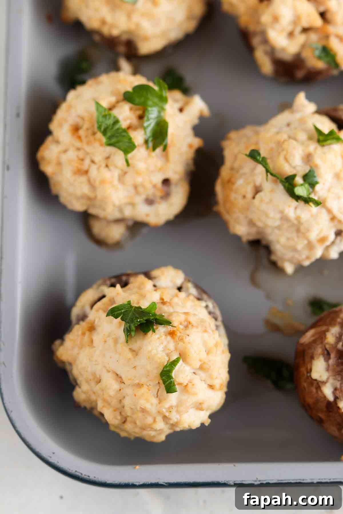 Baked stuffed mushrooms on a baking sheet.