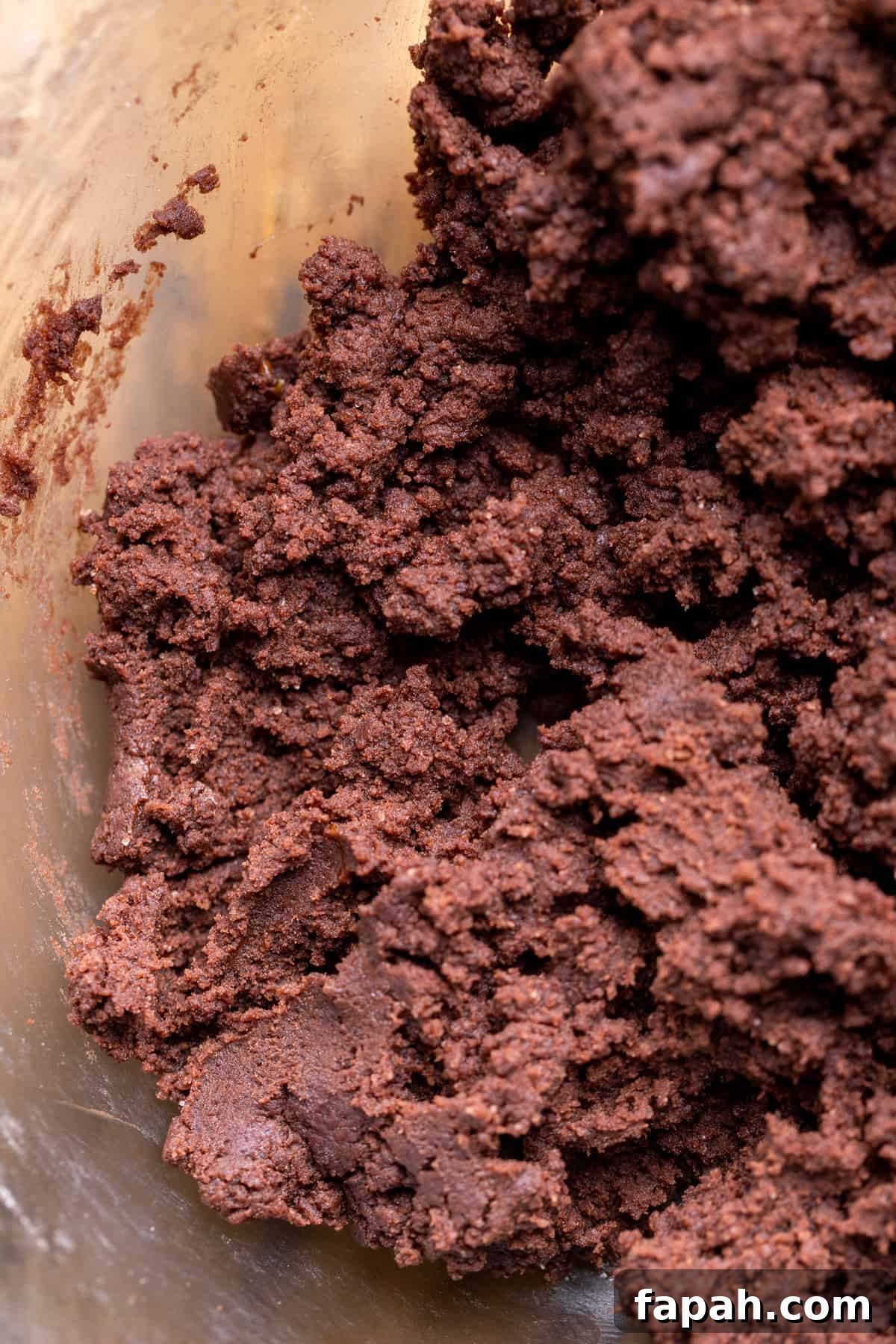 Festive Christmas Tree Cookie Recipes for Holiday Baking 5 Chocolate cookie dough in a glass bowl.