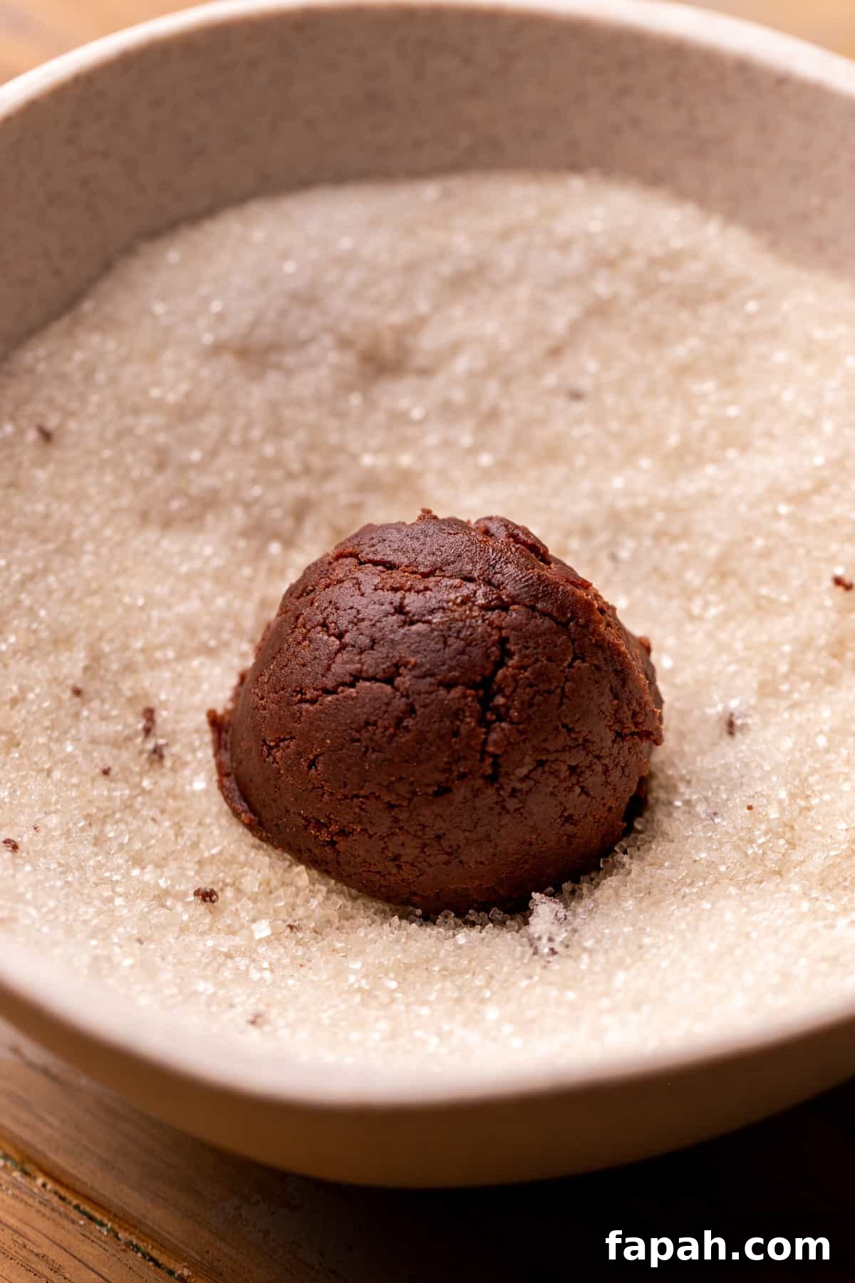 Festive Christmas Tree Cookie Recipes for Holiday Baking 6 Cookie dough ball in a bowl of sugar.