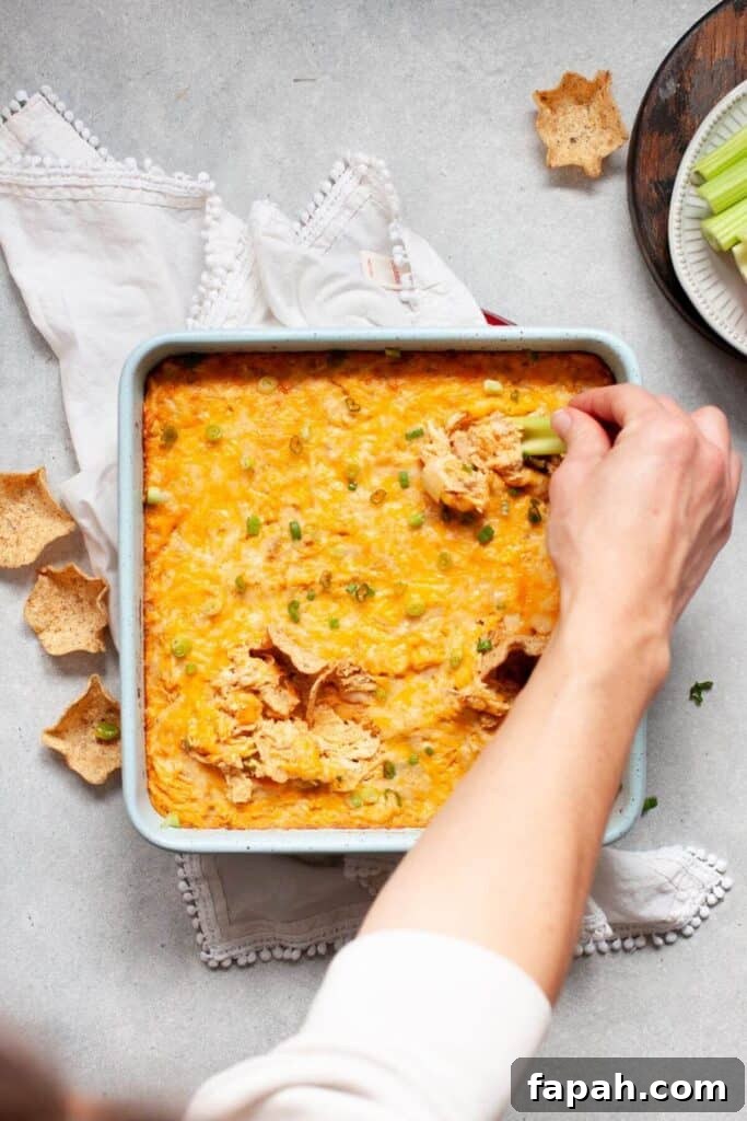 dipping chip into keto buffalo chicken dip