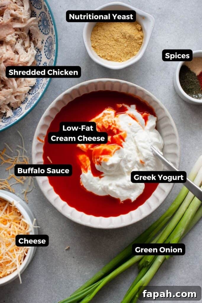 all ingredient in healthy buffalo chicken dip in bowls with labels