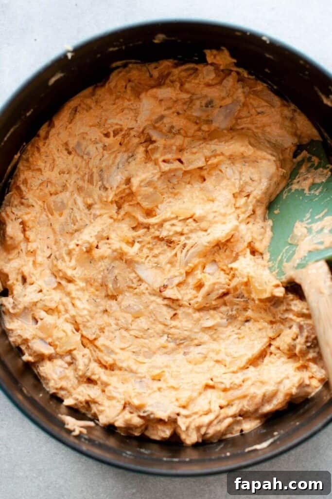 greek yogurt, buffalo sauce, and shredded chicken in a mixing bowl