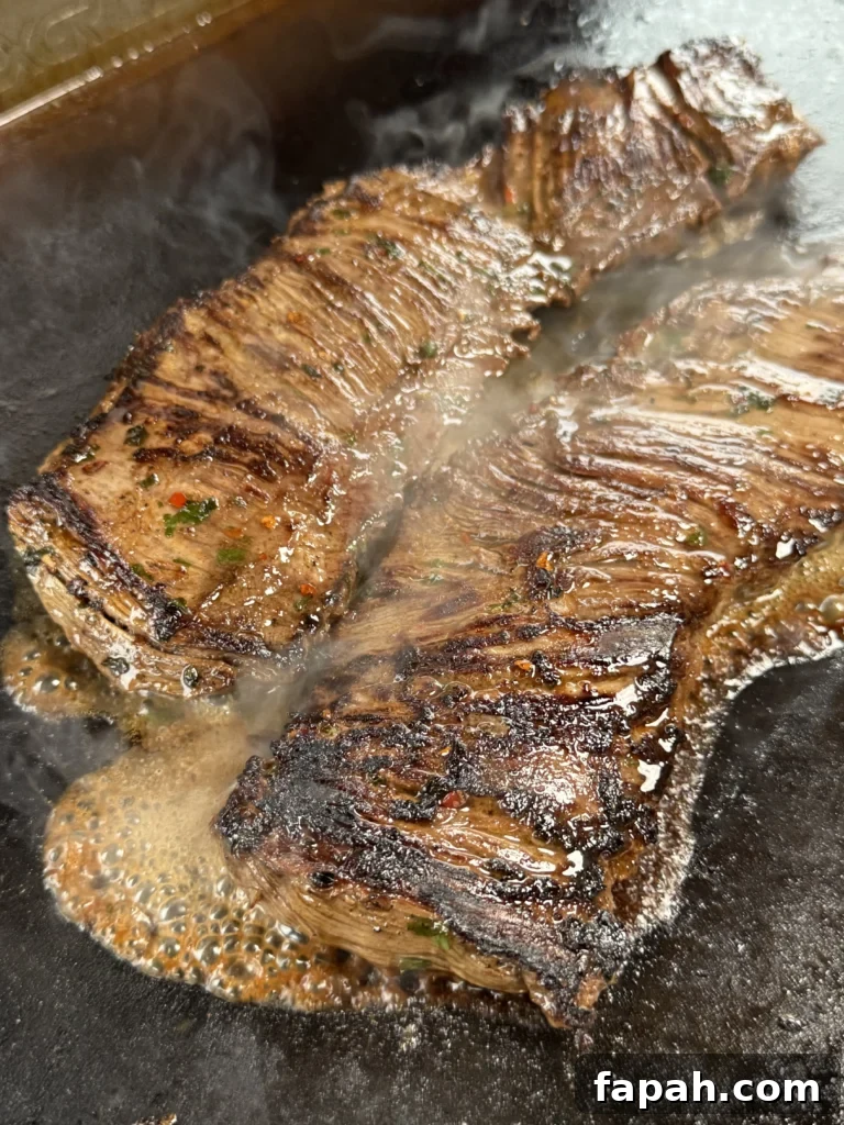 cooking the steak on a cast iron for surf n turf tacos
