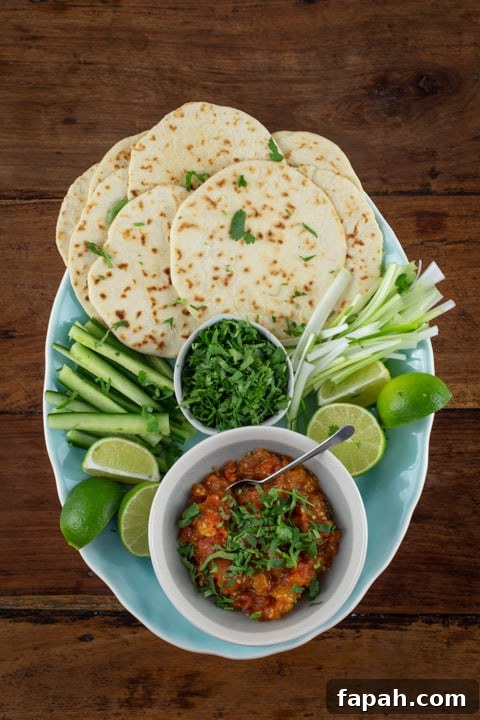 pale blue patter of homemade taco shells and sides to serve with crispy roast duck