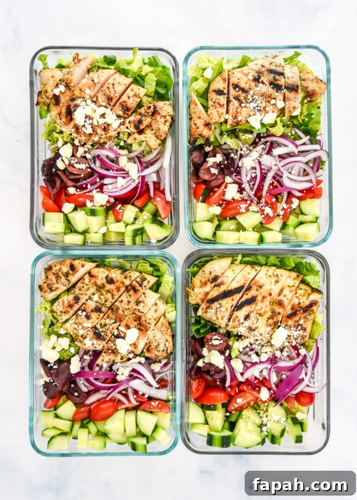 greek chicken salad meal prep in four glass meal prep containers.