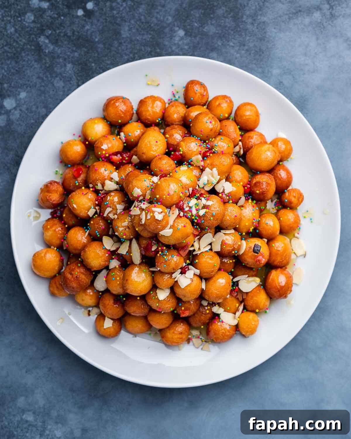 Podcast 27: Christmas Cookies to Try and Ones to Skip 2 Overhead shot of white platter with struffoli on blue board.