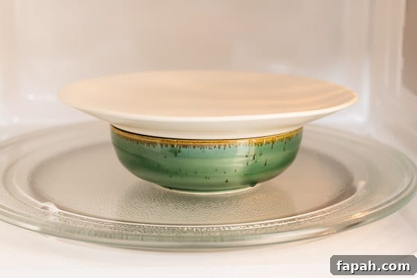 Cheesy Microwave Scrambled Eggs in 2 Minutes 4 Bowl with a lid in the microwave