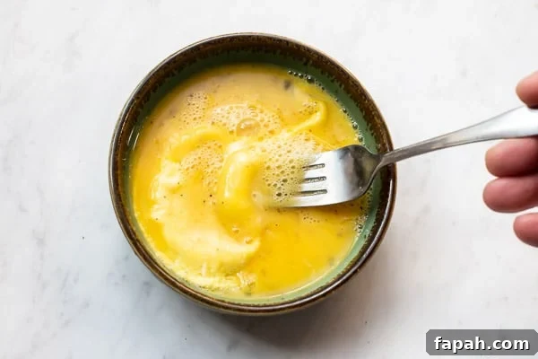 Cheesy Microwave Scrambled Eggs in 2 Minutes 5 Par cooked eggs being stirred