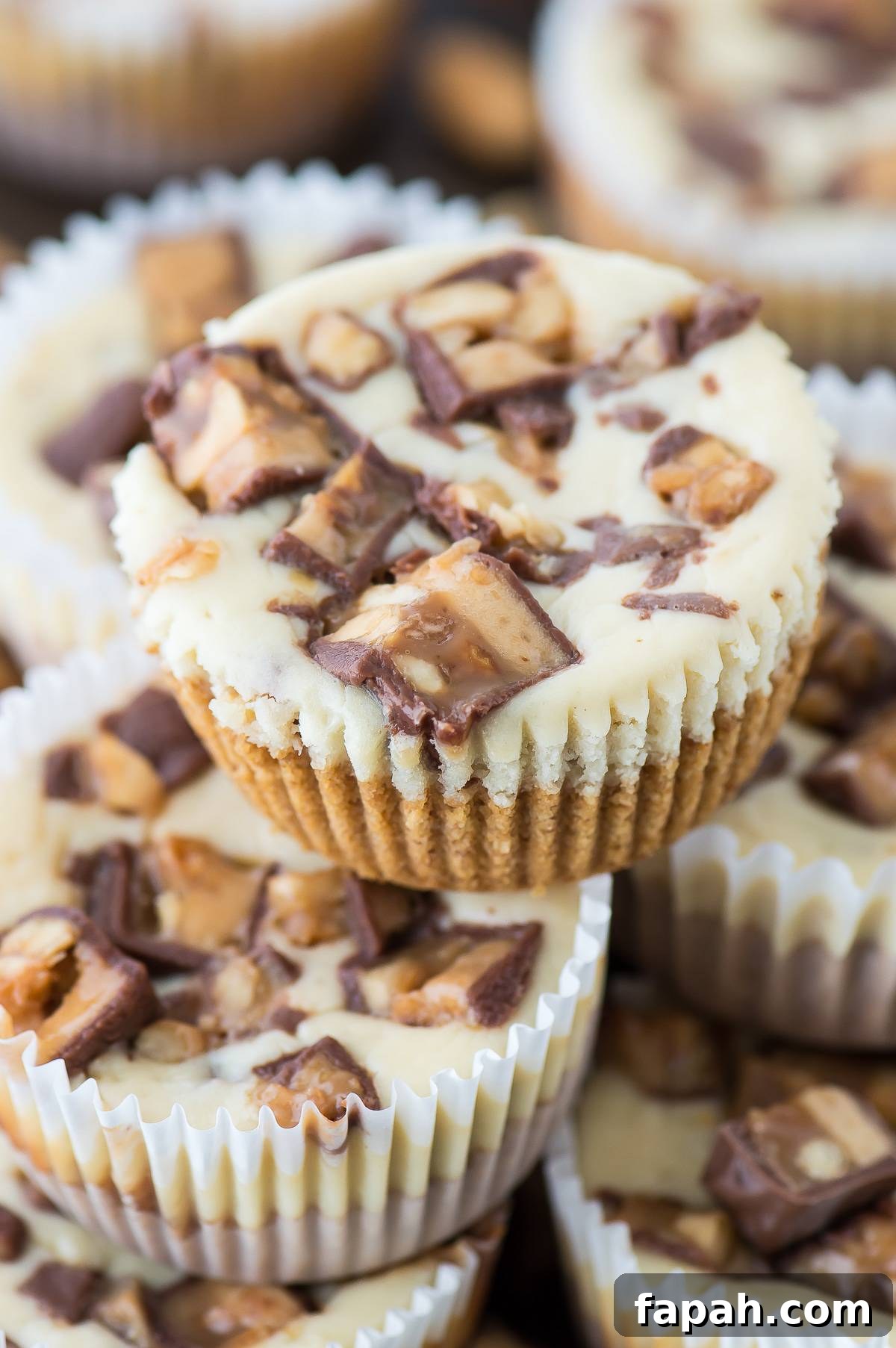 Mini Snickers Cheesecakes: Bite-Sized Candy Bar Desserts 6 7 ingredient mini snicker’s cheesecake recipe made in a muffin pan!