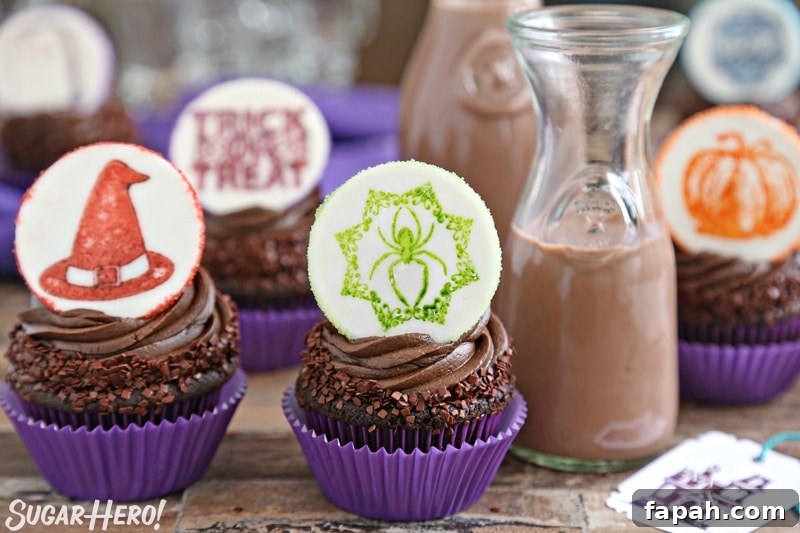 Stamped Halloween Cupcakes - group of double chocolate cupcakes topped with a Halloween fondant plaque, with chocolate milk | From SugarHero.com