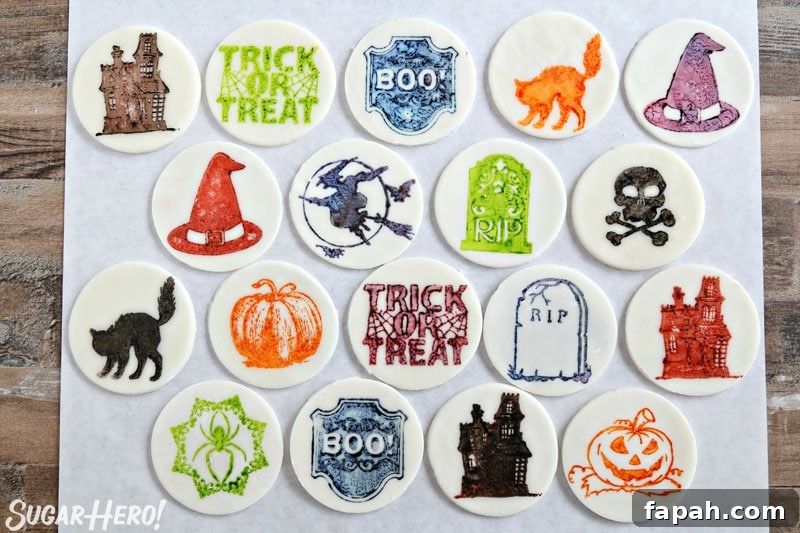 Stamped Halloween Cupcakes - group of fondant circles stamped with different Halloween designs and colors | From SugarHero.com