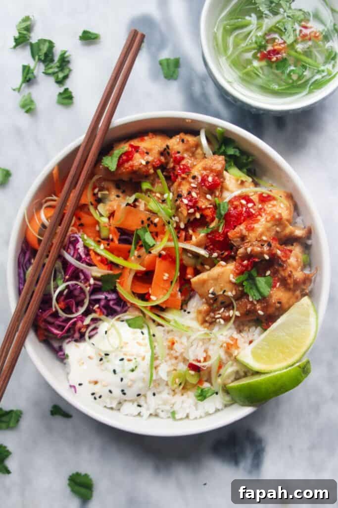 Grilled chicken poke bowl on a grey marble background.