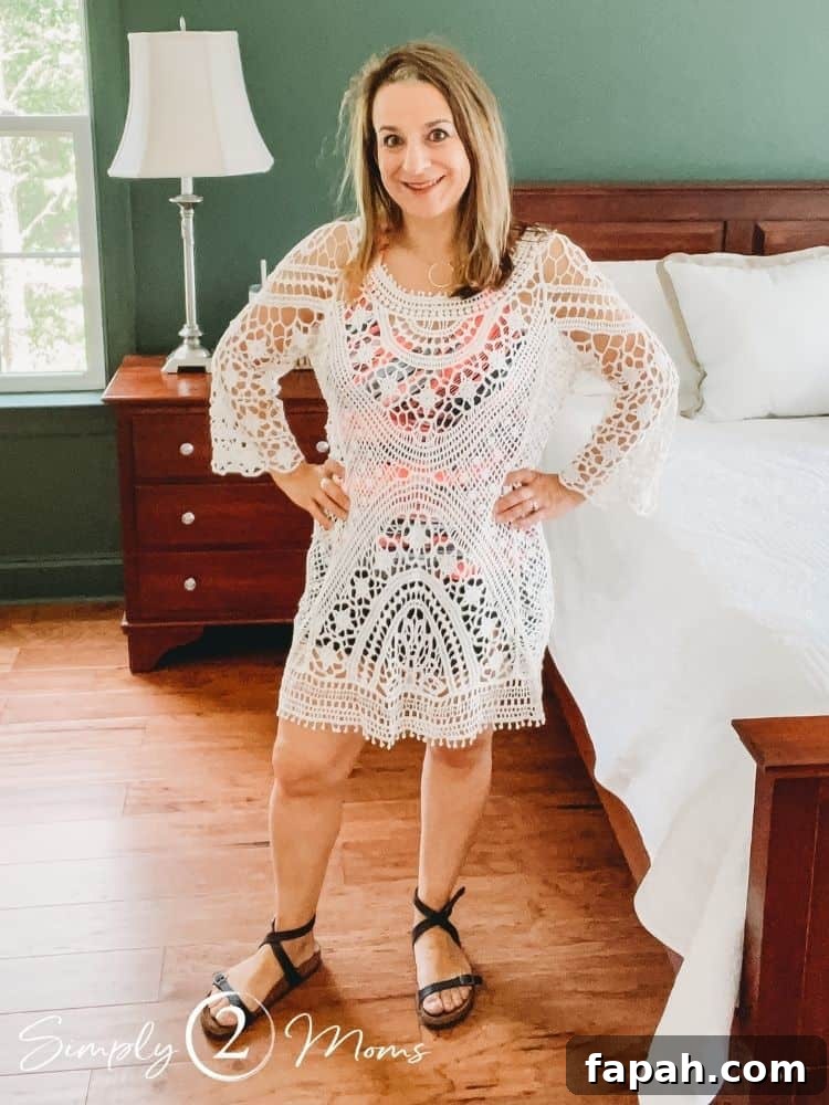 Woman wearing a white lace crochet swim coverup dress and black ankle strip Birkenstocks