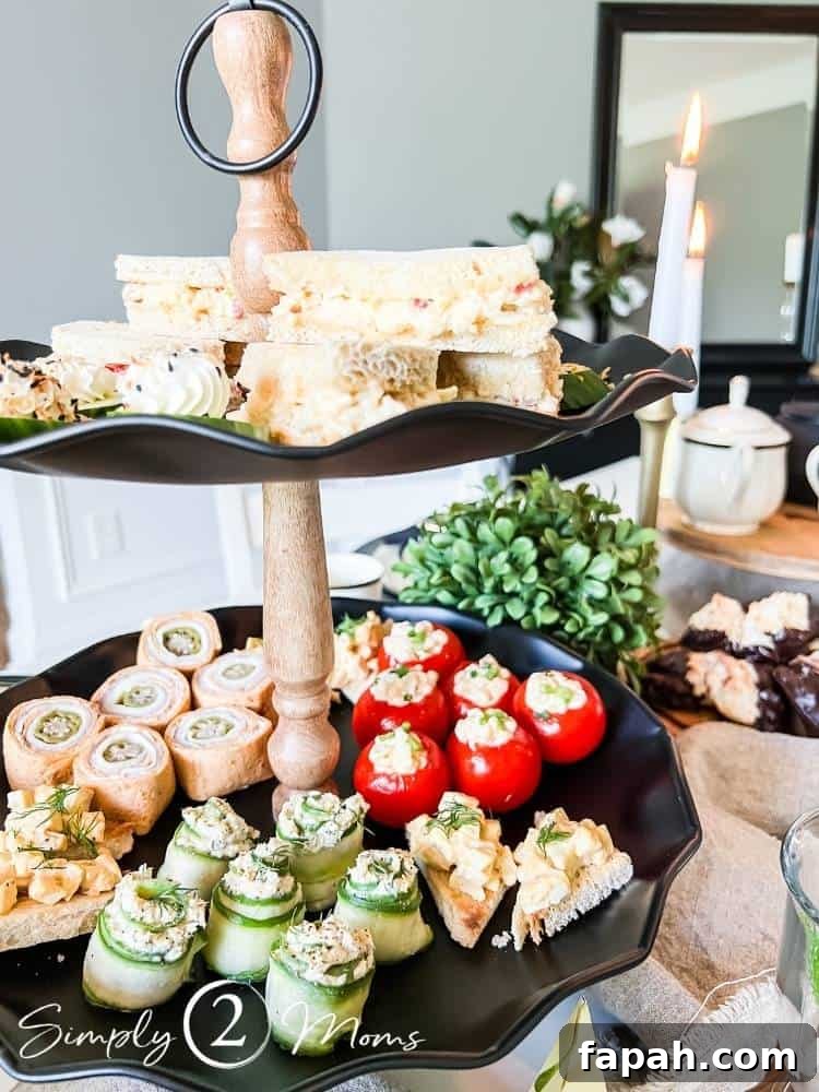 two tiered tray filled with tea party food