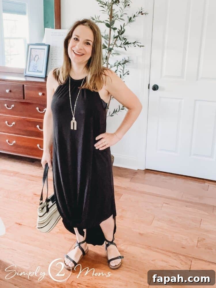 Woman wearing a high neck sleeveless maxi sundress knotted at the bottom.