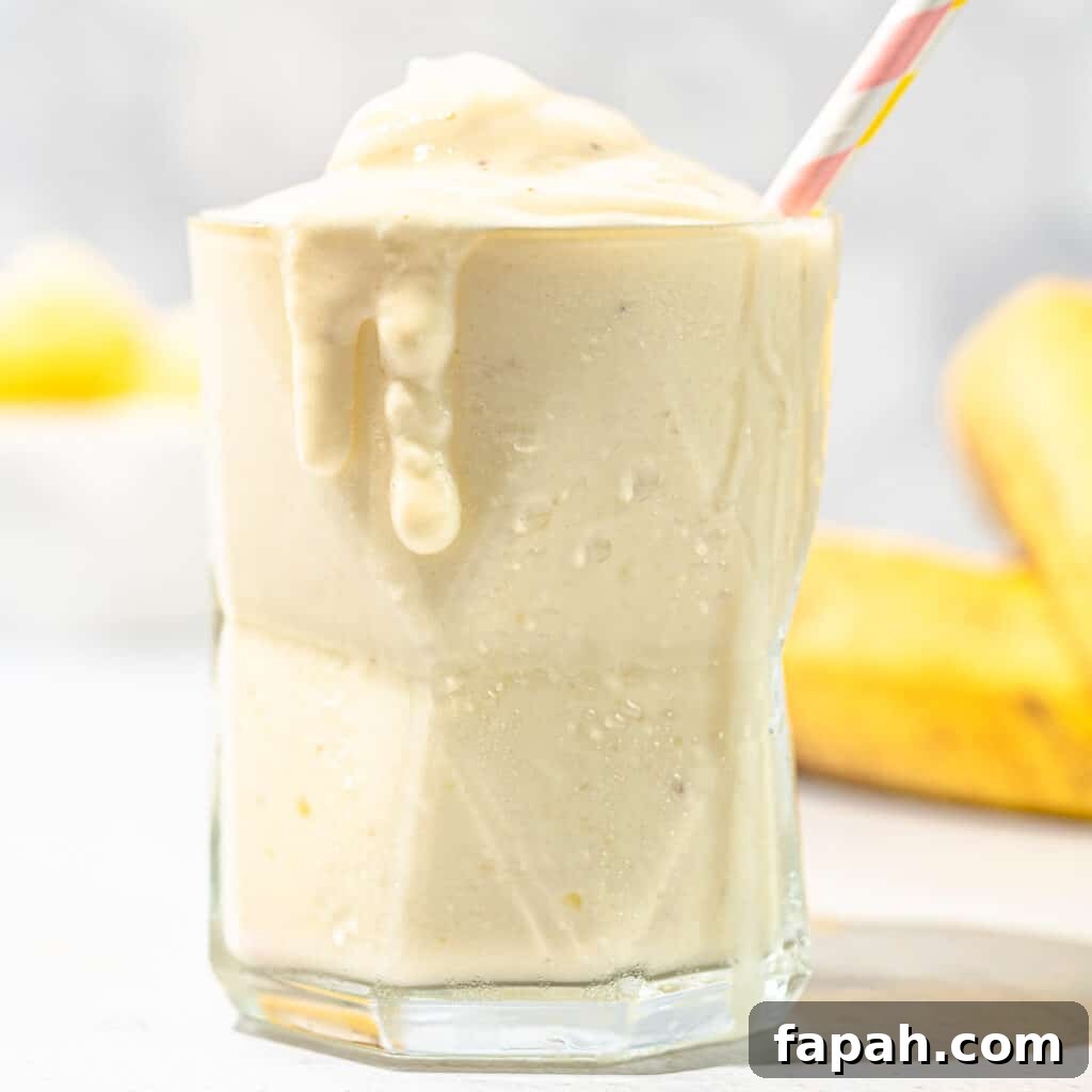 pineapple banana smoothie with bananas in background
