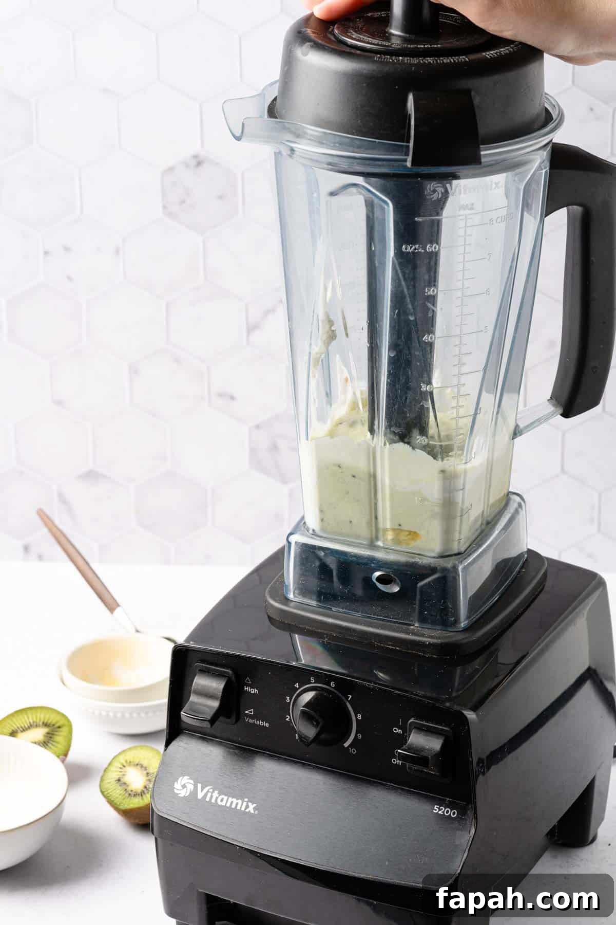 banana yogurt and kiwi being blended in blender