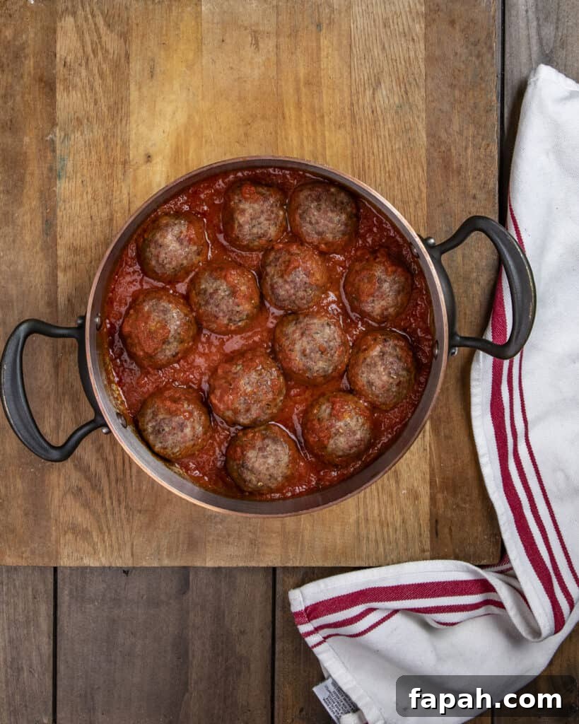 Smoked Meatball Sliders Recipe: Juicy, Smoky Party Sandwiches 8 Meatballs simmering in sauce