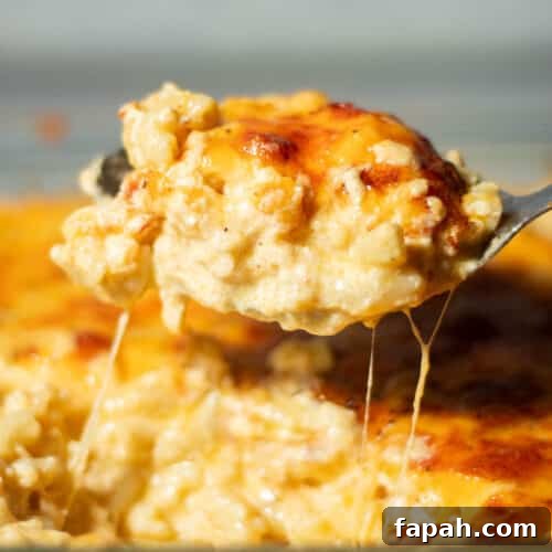 Spoon scooping southern baked mac and cheese.