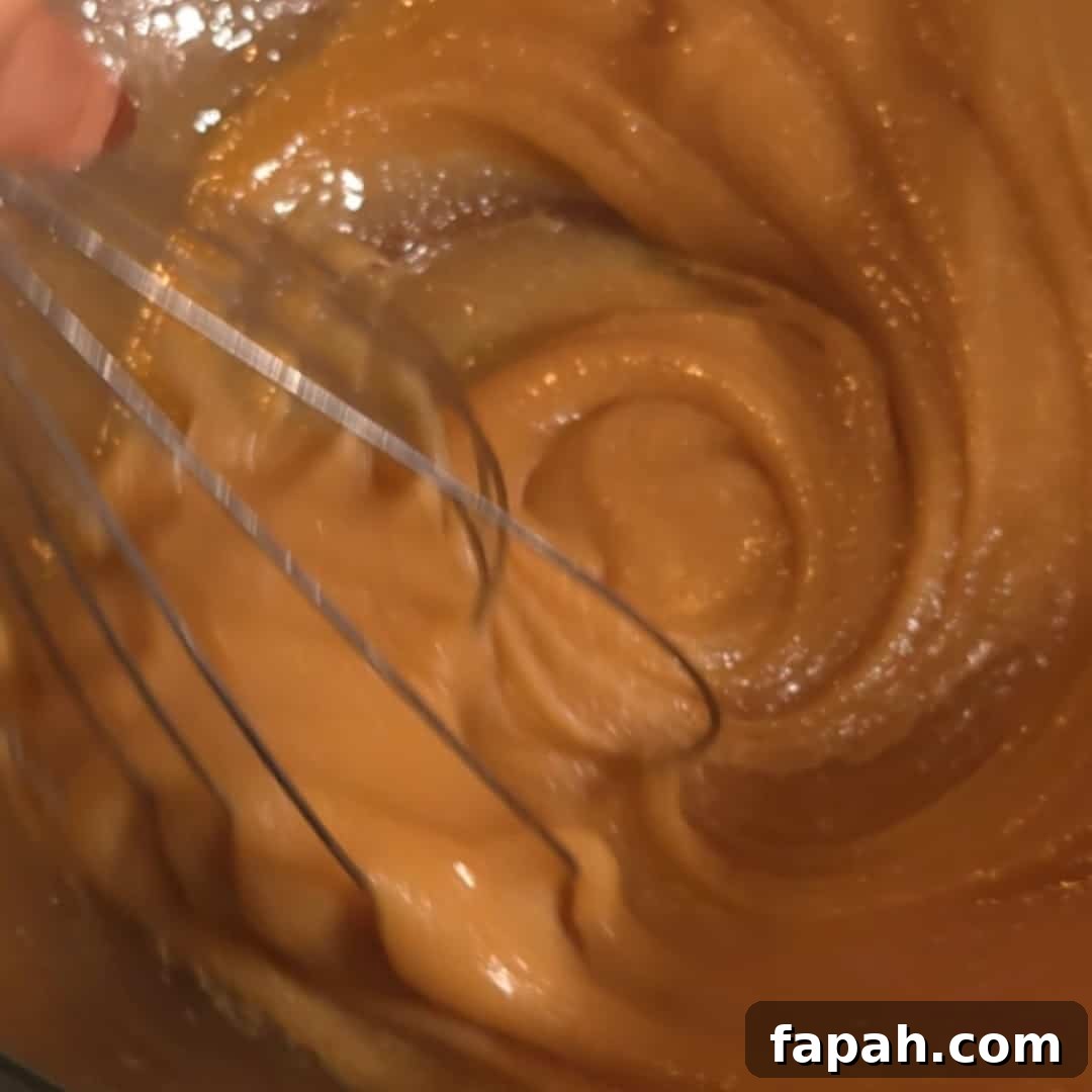Chocolate Chip and Pecan Pie Recipe: Chocolate-Pecan Pie Guide 7 Whisking together brown sugar, butter, and corn syrup to create the smooth filling for chocolate chip pecan pie.