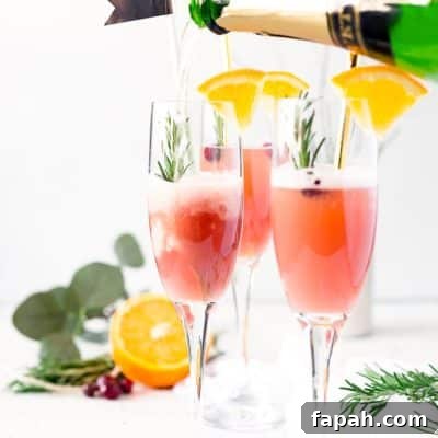  This Cranberry Orange Mimosa is the perfect cocktail for winter brunch! Made with cranberry and orange juice and champagne it's a fruity drink that you can serve up for Christmas or New Year's Eve or any other weekend celebration!