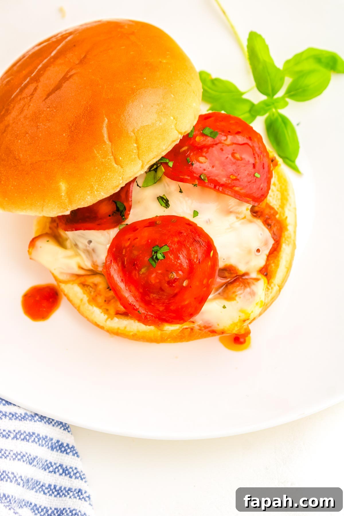 Pizza Burger Recipe: How to Make Savory Pizza-Style Burgers 2 The finished pizza burgers on a white plate.