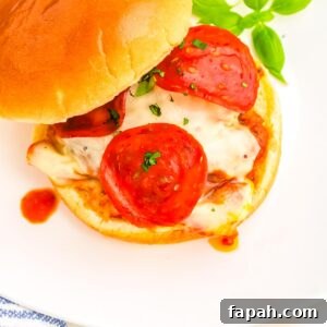 Pizza Burger Recipe: How to Make Savory Pizza-Style Burgers 8 The finished pizza burgers on a white plate.