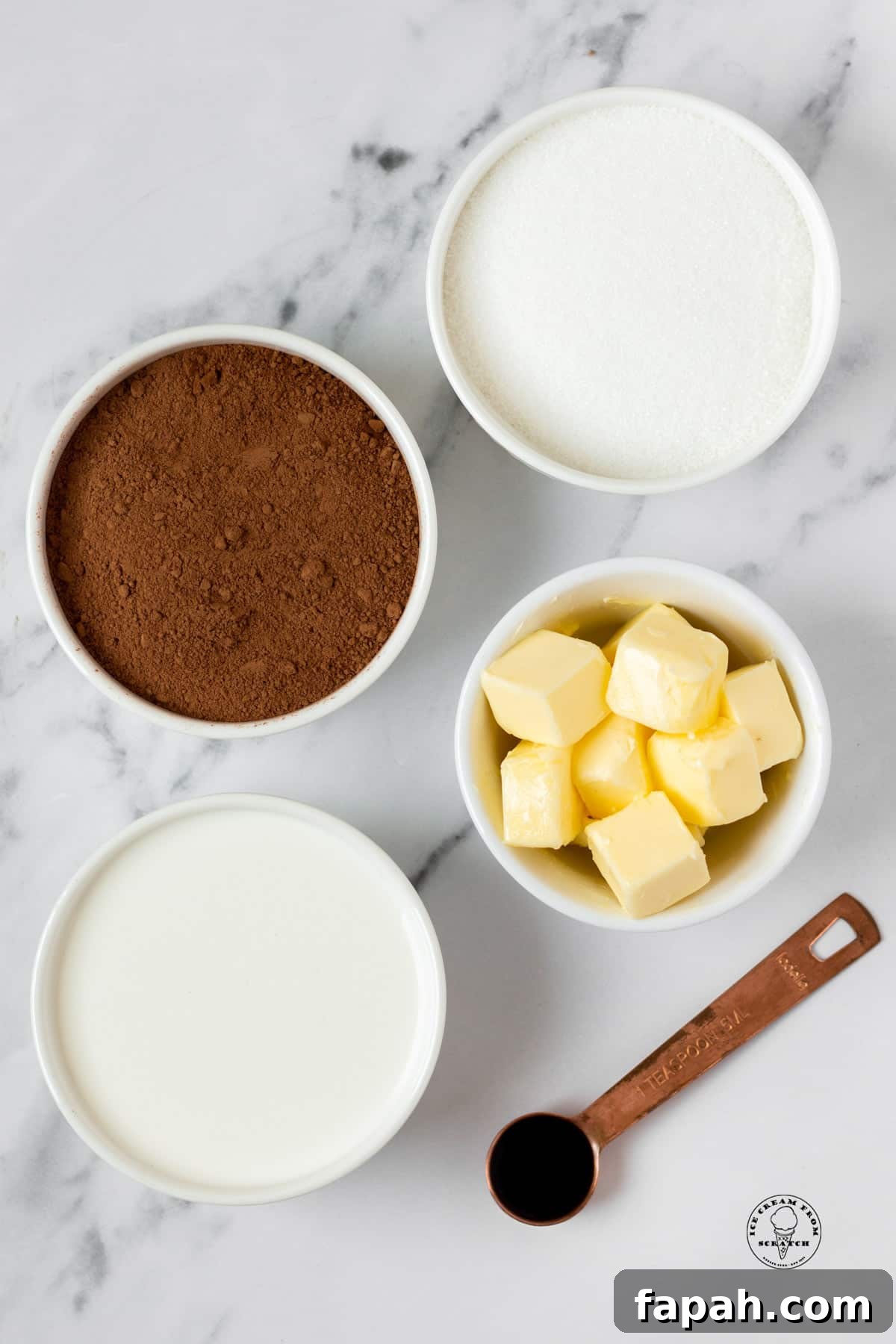 The ingredients in homemade hot fudge sauce, on a marble counter, viewed from overhead