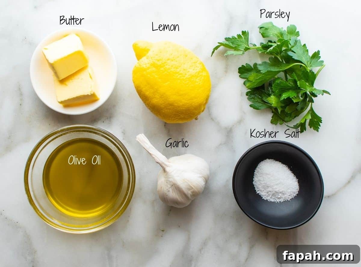 Lemon Garlic Butter Sauce Ingredients on a white marble board