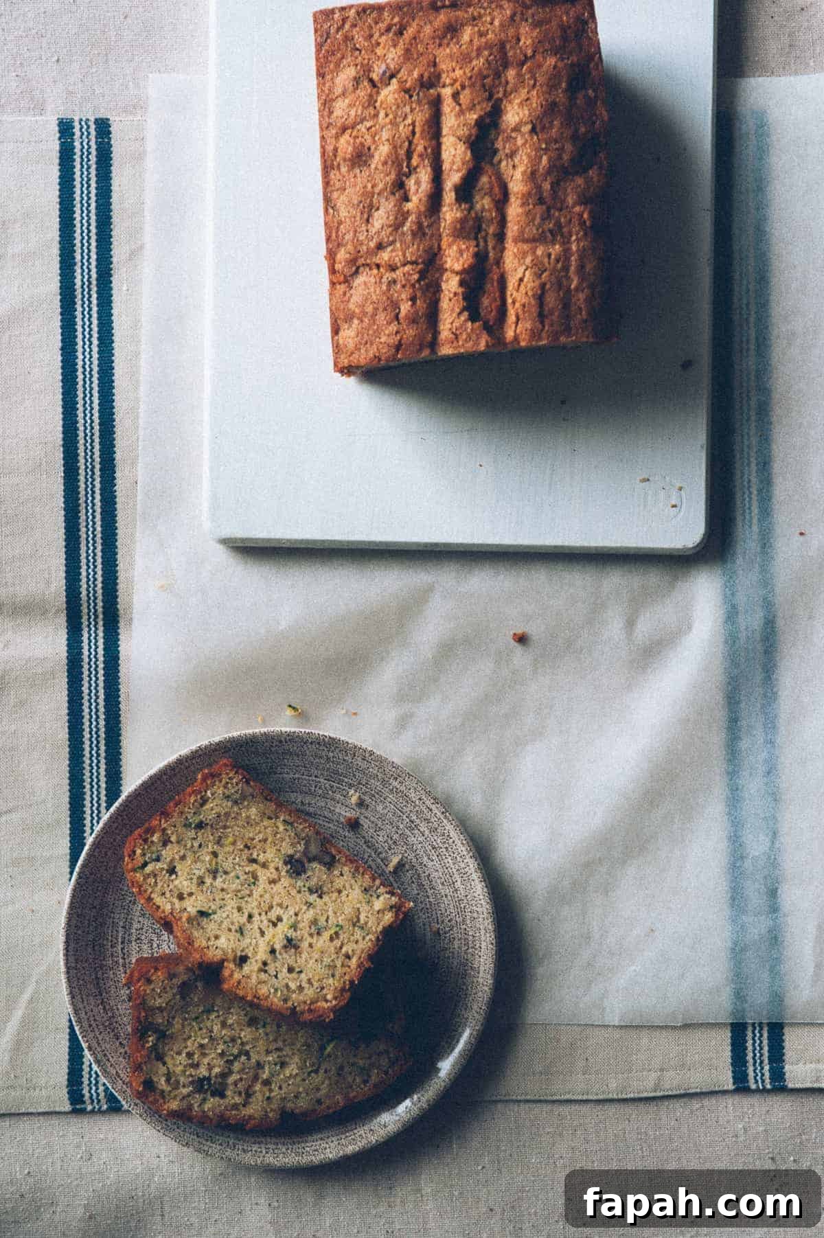 a birds eye view of a zucchini bread sliced on a plate