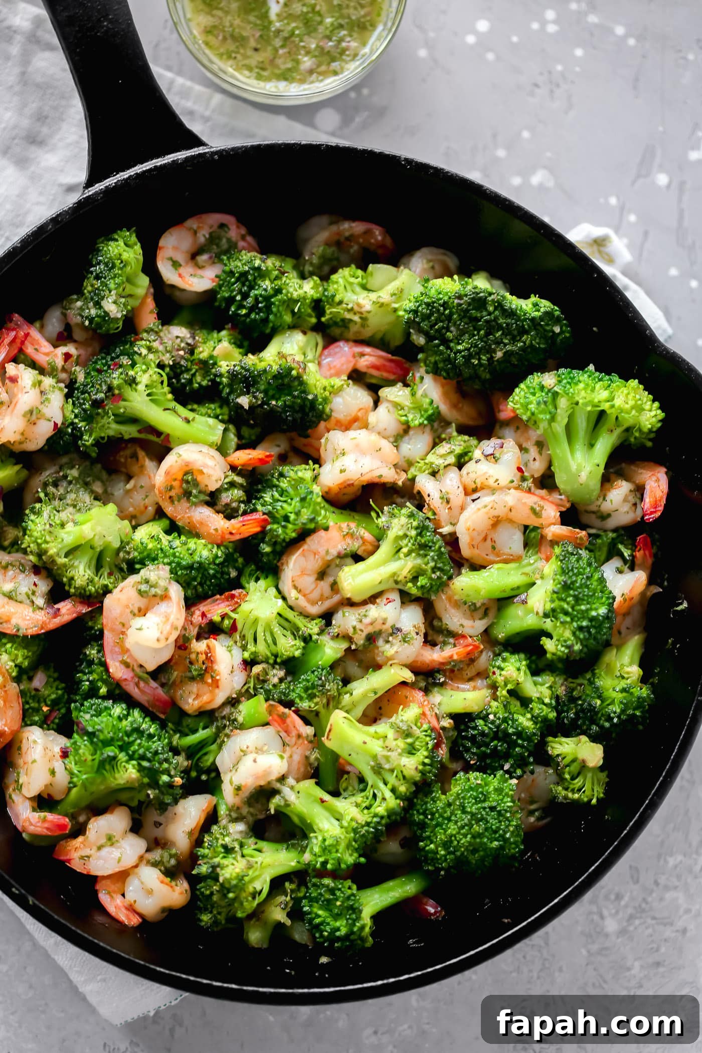 60 Delicious Whole30 Recipes for Every Meal and Snack 15 overhead view of a cast iron skillet containing shrimp and broccoli