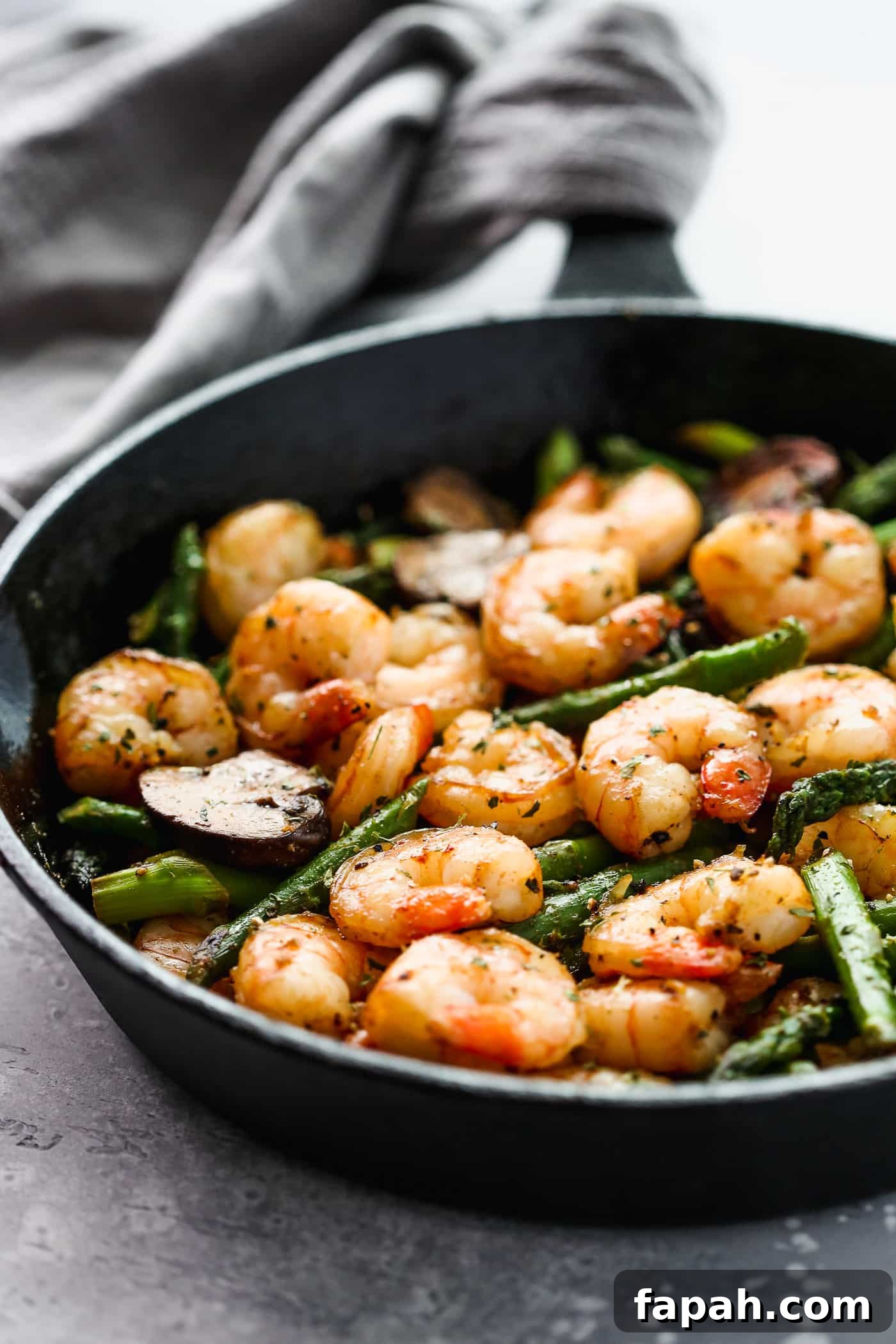 60 Delicious Whole30 Recipes for Every Meal and Snack 17 shrimp, asparagus and mushroom in a cast iron skillet