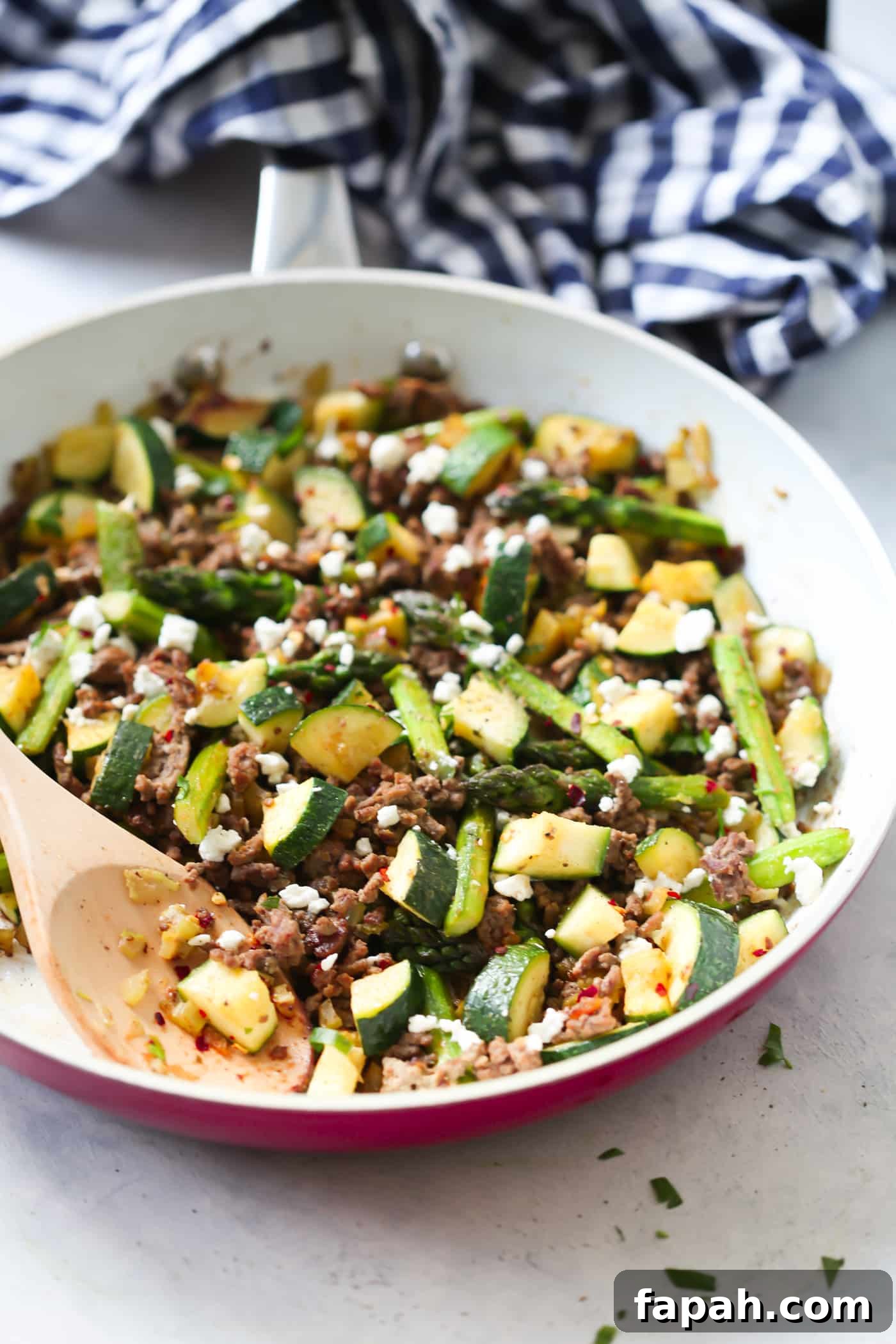 60 Delicious Whole30 Recipes for Every Meal and Snack 20 ground beef, asparagus and zucchini in a white and red skillet