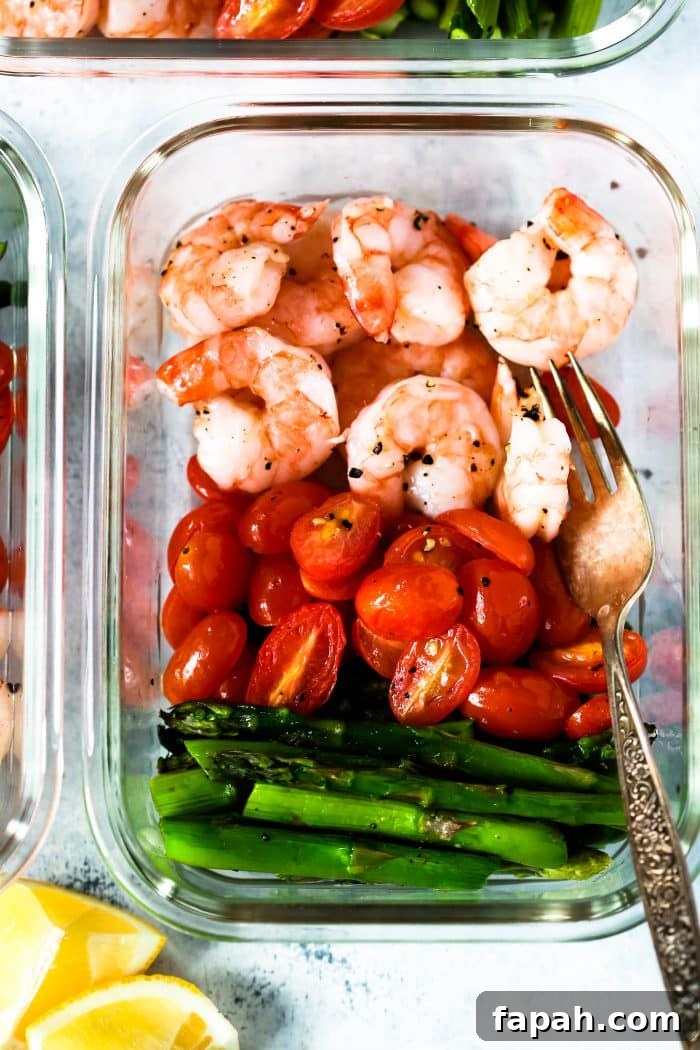 60 Delicious Whole30 Recipes for Every Meal and Snack 28 overhead view of shrimp and asparagus meal prep in a glass bowl