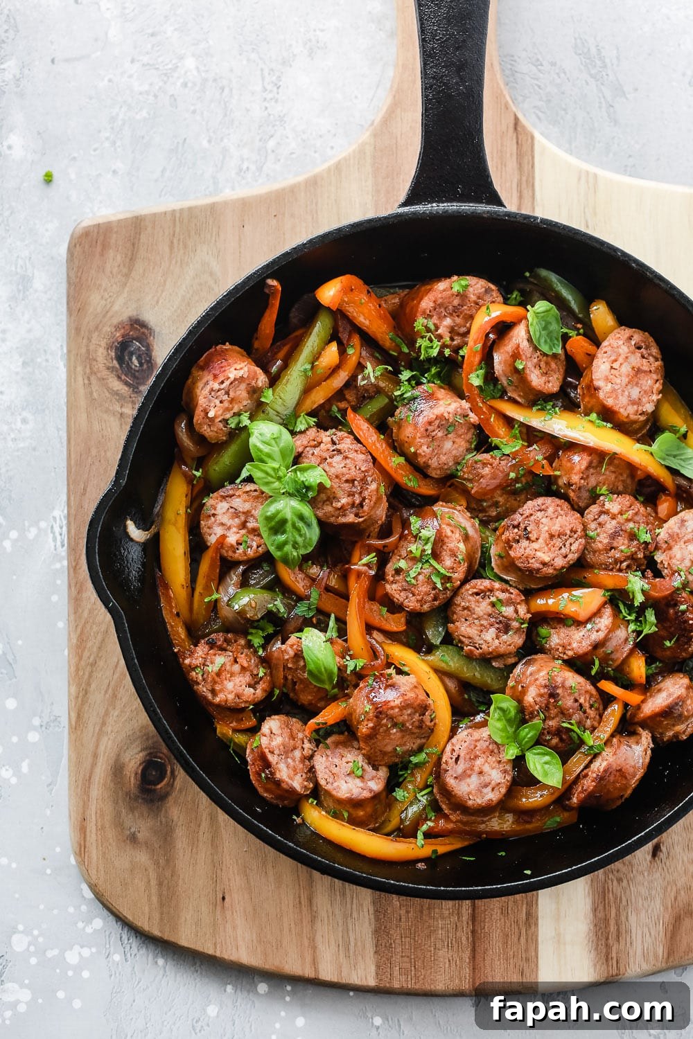 60 Delicious Whole30 Recipes for Every Meal and Snack 5 overhead view of sausage and bell pepper in a cast iron skillet