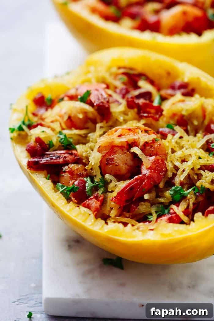 60 Delicious Whole30 Recipes for Every Meal and Snack 47 Close-up of half a spaghetti squash with shrimp on a marble board.