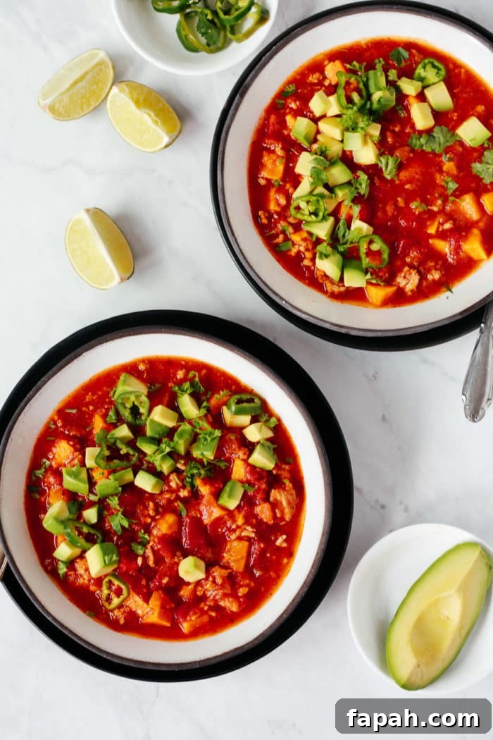60 Delicious Whole30 Recipes for Every Meal and Snack 51 overhead view of pumpkin chili in 2 white and black ceramic bowls
