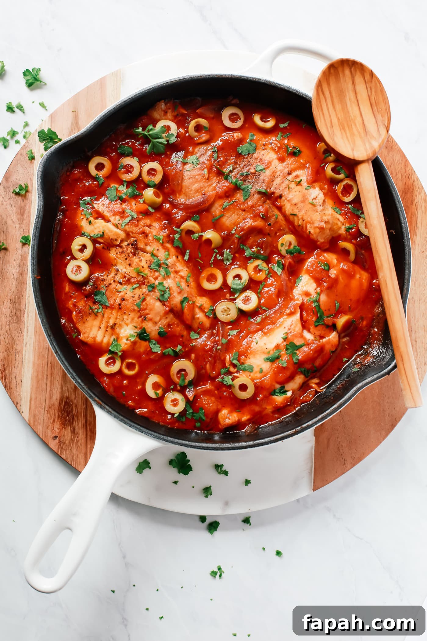 60 Delicious Whole30 Recipes for Every Meal and Snack 8 overhead view of a white skillet containing tilapia in a tomato sauce