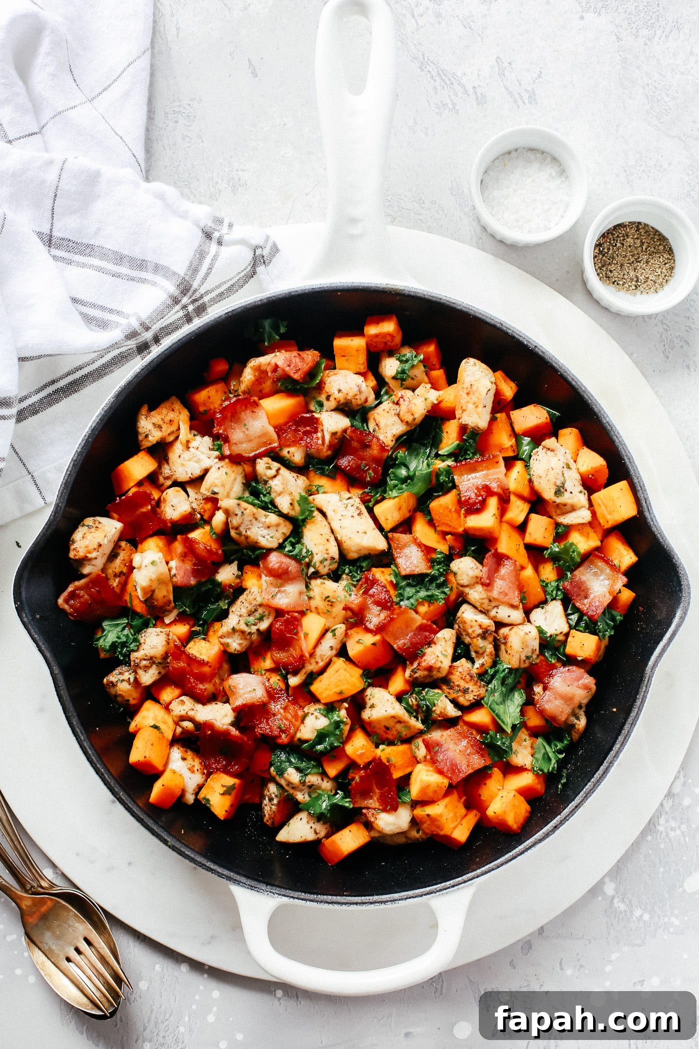 60 Delicious Whole30 Recipes for Every Meal and Snack 9 chicken, bacon and kale in a cast iron skillet
